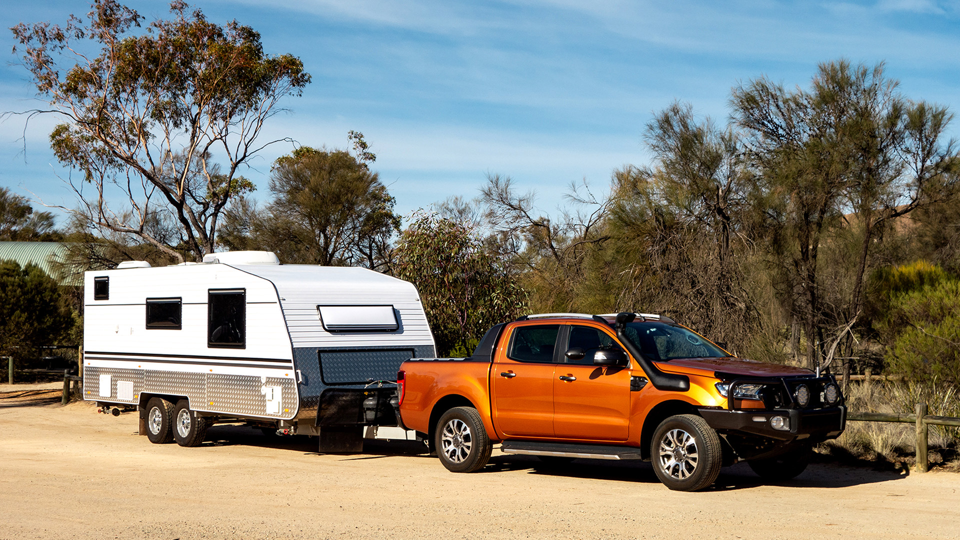 Off Road Pickup Car With Air Intakes And A White Caravan Trailer