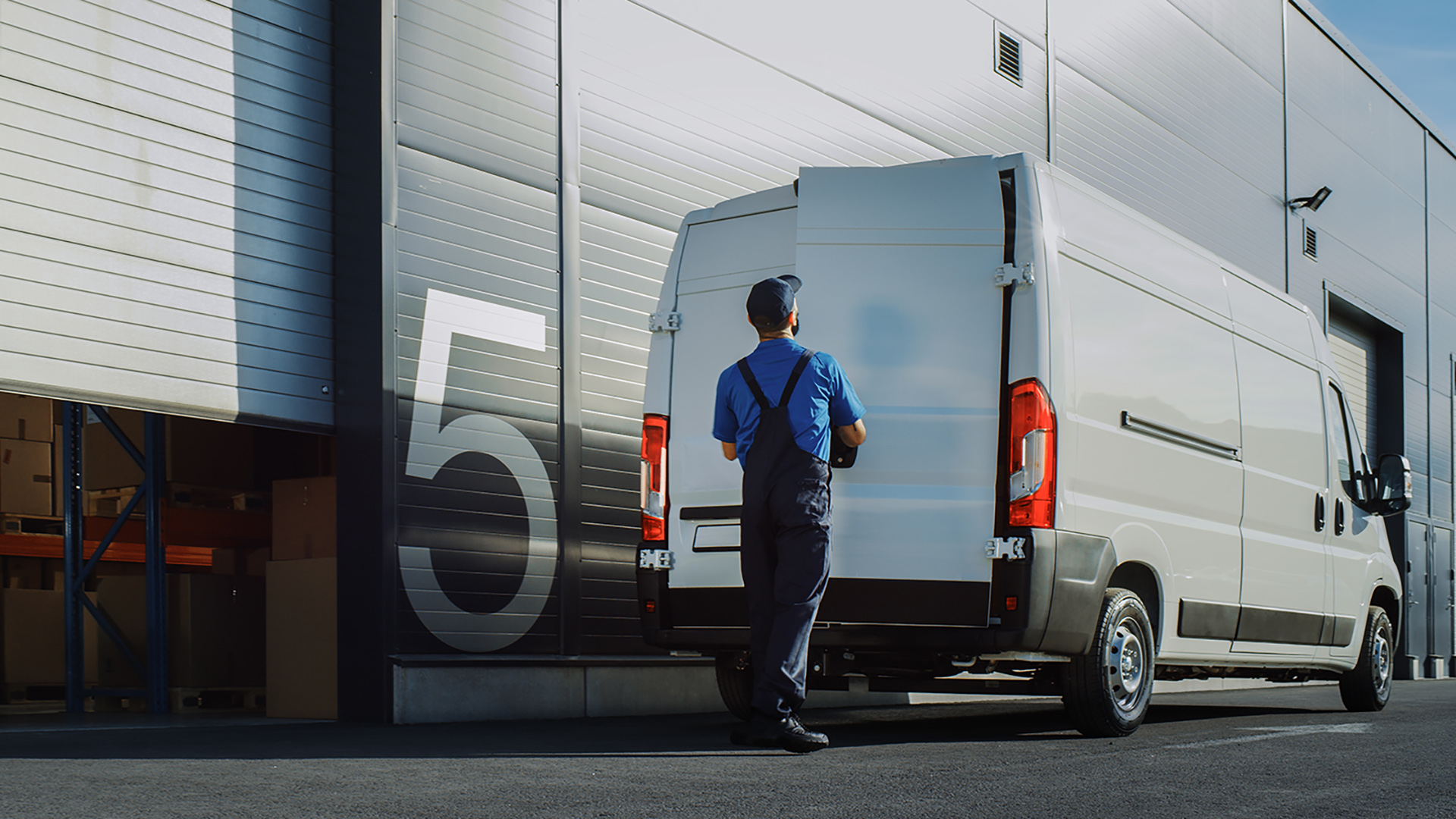 Outside Of Logistics Distributions Warehouse Worker Loading Deli